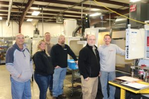 The team from Torque Tools watches machinist Doug Smith verify settings on Haas CNC machine. From Left (photo by Deveron Milne) TTI Quality Manager Mike Smith, TTI Accountant/Quality Control Shelly Wedward, IBT Production Manager Roddy Ferrell, TTI General Manager Bobby Branam, IBT Quality Manager Bob Keller, IBT machinist Doug Smith.